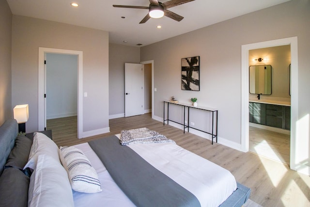 bedroom with light wood-style flooring, recessed lighting, connected bathroom, and baseboards