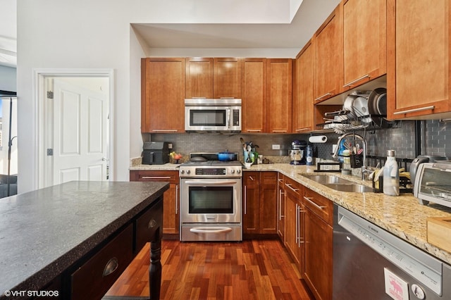 1464 S Michigan Ave Unit 1401, Chicago, IL 60605 - kitchen with stainless steel appliances, dark wood finished floors, decorative backsplash, light stone countertops, and brown cabinetry