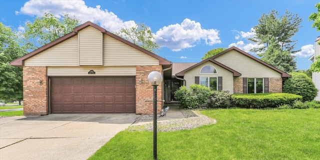 single story home featuring brick siding, a front yard, concrete driveway, and an attached garage