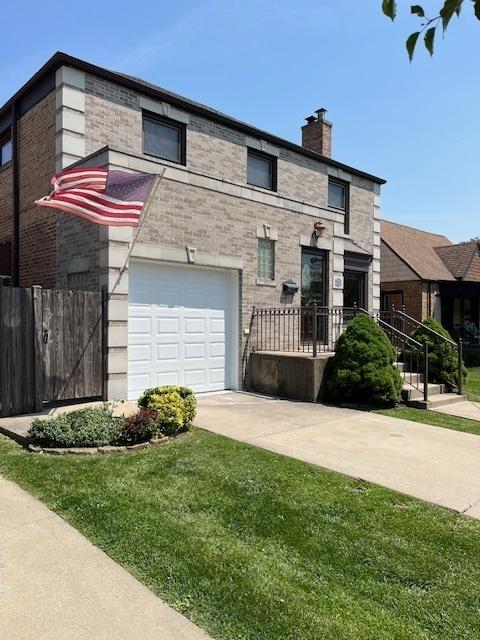 1911 N 73rd Ave N, Elmwood Park, IL 60707 - view of front of home with an attached garage, a chimney, driveway, and brick siding