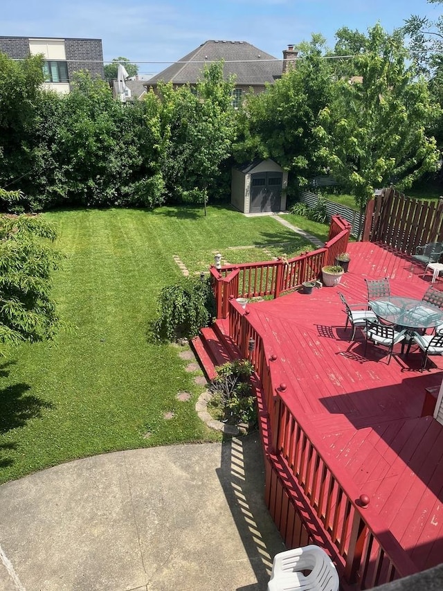 1911 N 73rd Ave N, Elmwood Park, IL 60707 - view of green lawn with a storage shed, outdoor dining space, and a deck