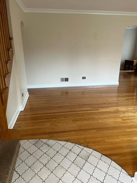1911 N 73rd Ave N, Elmwood Park, IL 60707 - unfurnished room featuring arched walkways, light wood-style flooring, and ornamental molding