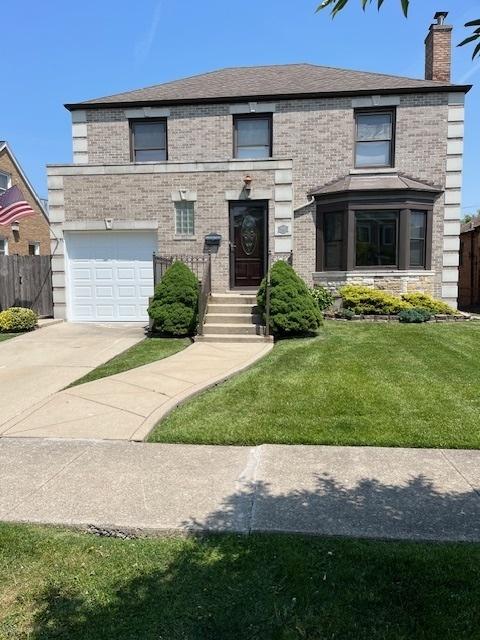 1911 N 73rd Ave N, Elmwood Park, IL 60707 - view of front of home with an attached garage, concrete driveway, a chimney, and stone siding
