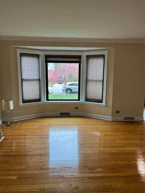 1911 N 73rd Ave N, Elmwood Park, IL 60707 - spare room featuring wood finished floors and ornamental molding