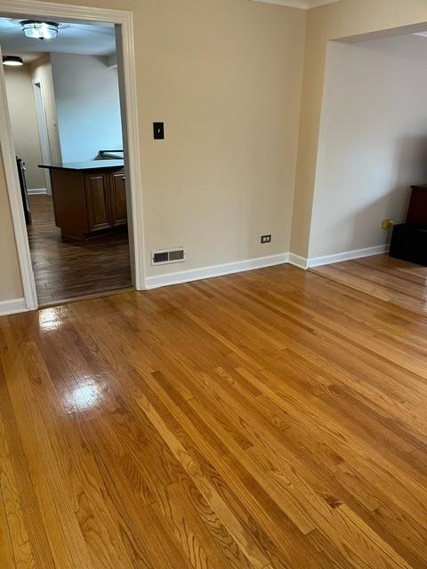 1911 N 73rd Ave N, Elmwood Park, IL 60707 - unfurnished room with light wood finished floors and baseboards