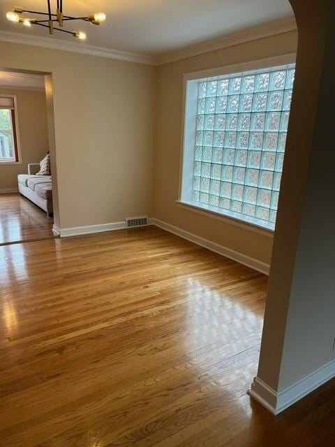 1911 N 73rd Ave N, Elmwood Park, IL 60707 - spare room with arched walkways, crown molding, a chandelier, and wood finished floors