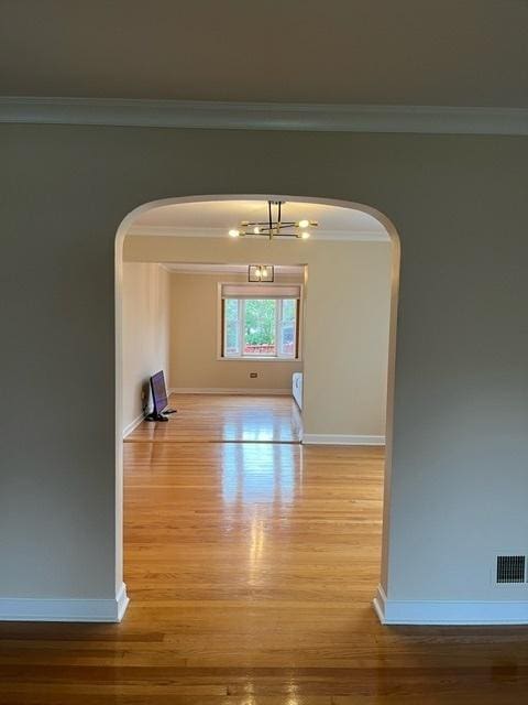 1911 N 73rd Ave N, Elmwood Park, IL 60707 - hall with arched walkways, wood finished floors, a chandelier, and ornamental molding