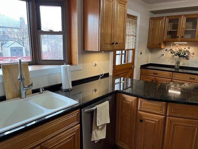 1911 N 73rd Ave N, Elmwood Park, IL 60707 - kitchen with stainless steel dishwasher, brown cabinets, healthy amount of natural light, and glass insert cabinets
