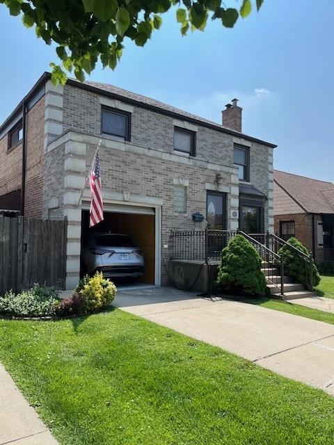 1911 N 73rd Ave N, Elmwood Park, IL 60707 - view of front of home with concrete driveway, an attached garage, brick siding, and a chimney