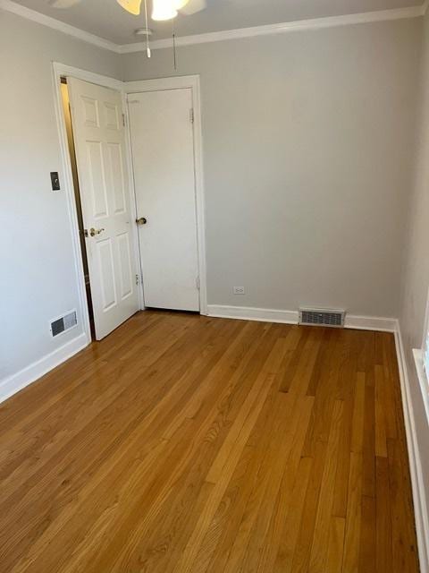 1911 N 73rd Ave N, Elmwood Park, IL 60707 - spare room with wood finished floors, a ceiling fan, and crown molding