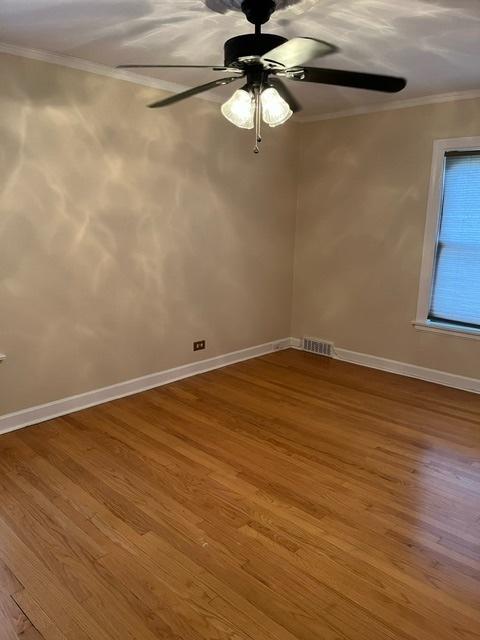 1911 N 73rd Ave N, Elmwood Park, IL 60707 - unfurnished room featuring crown molding, wood finished floors, and a ceiling fan