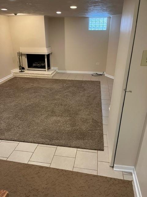 1911 N 73rd Ave N, Elmwood Park, IL 60707 - below grade area featuring light tile patterned flooring, light carpet, recessed lighting, and a fireplace