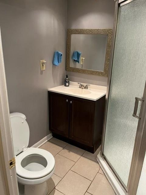 1911 N 73rd Ave N, Elmwood Park, IL 60707 - bathroom with vanity, a shower stall, and tile patterned floors