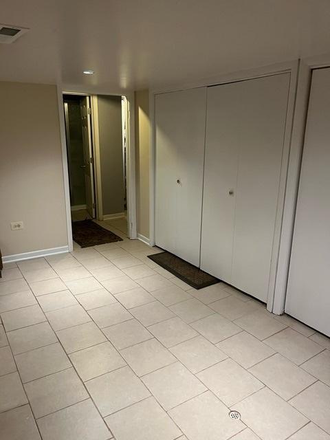 1911 N 73rd Ave N, Elmwood Park, IL 60707 - unfurnished bedroom with a closet and light tile patterned floors