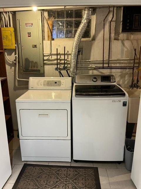 1911 N 73rd Ave N, Elmwood Park, IL 60707 - washroom with electric panel, washing machine and dryer, and light tile patterned flooring