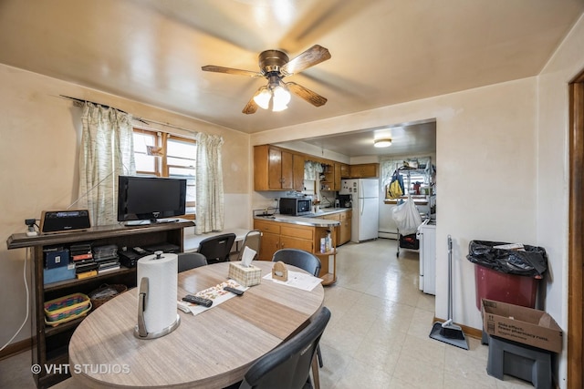 3101 S 53rd Ct, Cicero, IL 60804 - dining area with baseboards, ceiling fan, and a baseboard heating unit