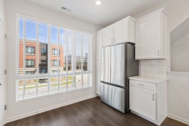 kitchen featuring visible vents, freestanding refrigerator, and a healthy amount of sunlight