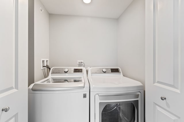 laundry area featuring washing machine and clothes dryer and laundry area