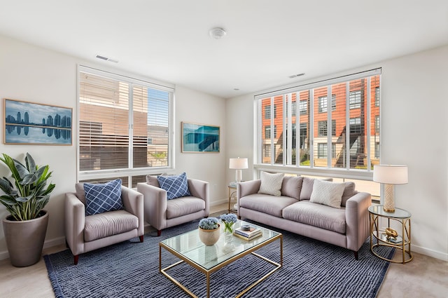 living area featuring visible vents and baseboards