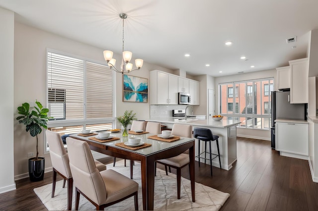 dining area with visible vents, recessed lighting, dark wood-style flooring, baseboards, and a notable chandelier