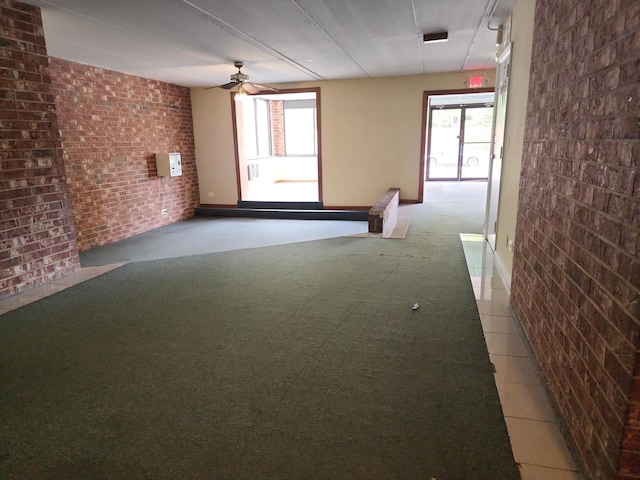 5011 S Valley Ln Unit 409, Streamwood, IL 60107 - spare room with plenty of natural light, brick wall, radiator, and ceiling fan