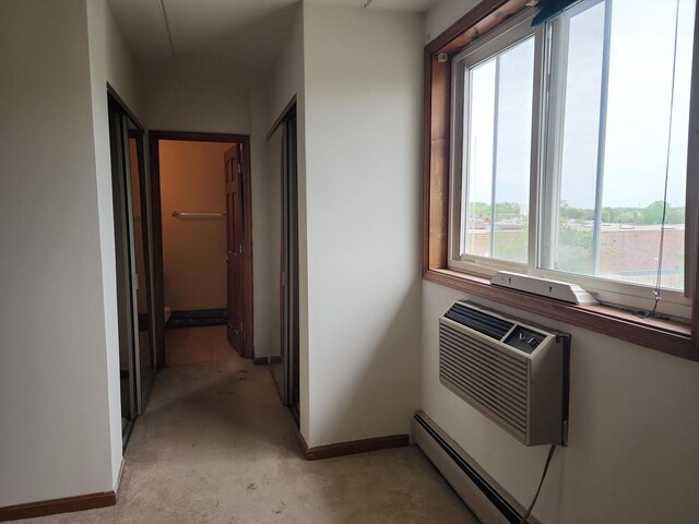 5011 S Valley Ln Unit 409, Streamwood, IL 60107 - corridor featuring light carpet and an AC wall unit