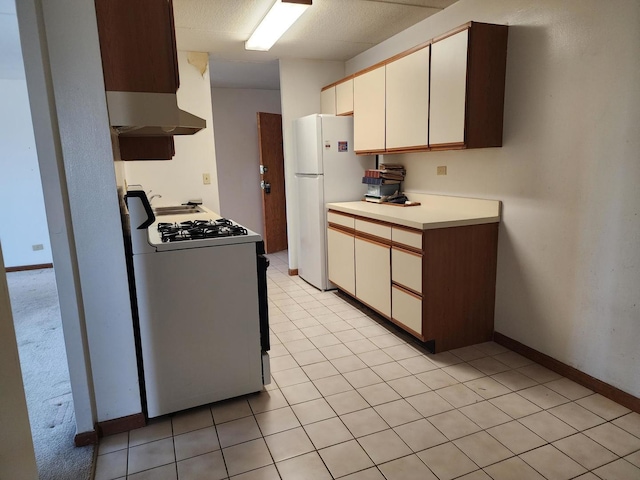 5011 S Valley Ln Unit 409, Streamwood, IL 60107 - kitchen with white appliances, wall chimney exhaust hood, light countertops, and white cabinetry
