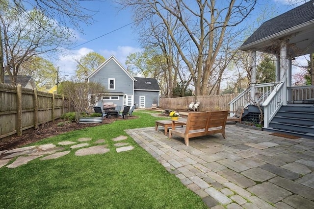 view of yard featuring a fenced backyard, an outbuilding, and a patio