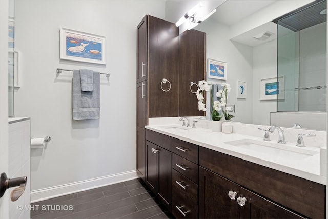 4845 N Damen Ave Unit 3S, Chicago, IL 60625 - full bathroom featuring a sink, visible vents, baseboards, and wood tiled floor