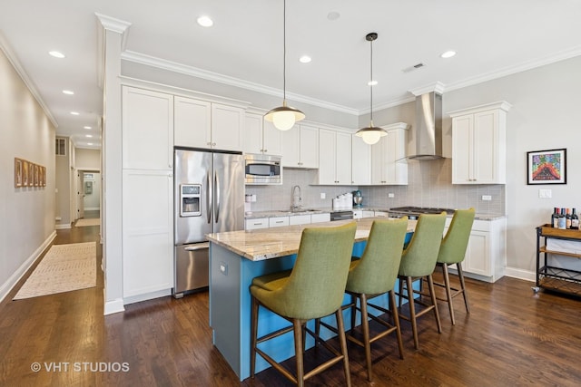 4845 N Damen Ave Unit 3S, Chicago, IL 60625 - kitchen featuring white cabinets, a sink, wall chimney range hood, stainless steel appliances, and a kitchen island