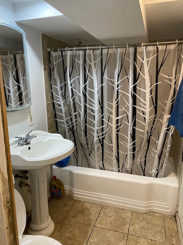full bathroom with a sink, shower / bath combo, and toilet