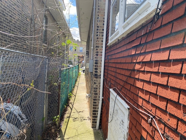 view of side of home featuring fence