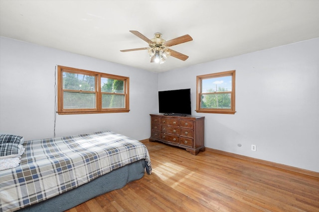 910 Sarah Ln, Aurora, IL 60502 - bedroom featuring multiple windows, wood finished floors, ceiling fan, and baseboards