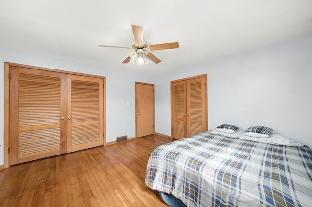 910 Sarah Ln, Aurora, IL 60502 - bedroom with wood finished floors, baseboards, ceiling fan, and multiple closets