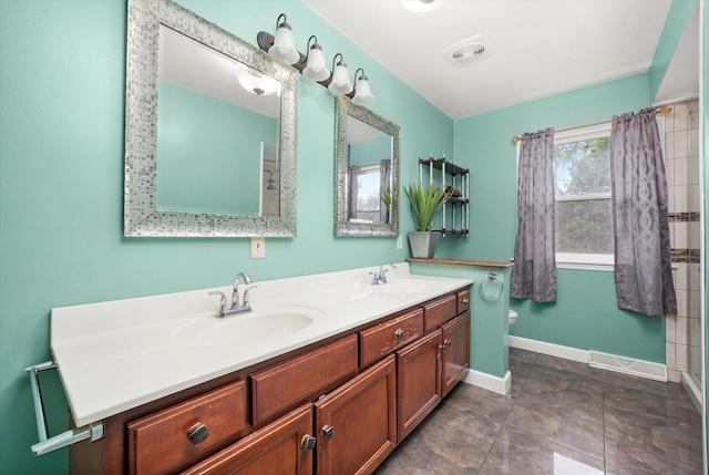 910 Sarah Ln, Aurora, IL 60502 - bathroom with double vanity, baseboards, toilet, and a shower