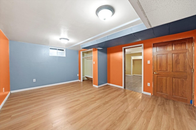910 Sarah Ln, Aurora, IL 60502 - below grade area featuring light wood-style floors and baseboards