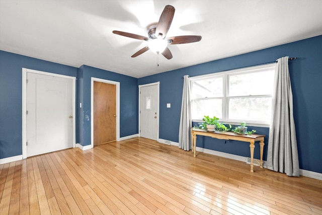 910 Sarah Ln, Aurora, IL 60502 - spare room with a ceiling fan, baseboards, and wood-type flooring