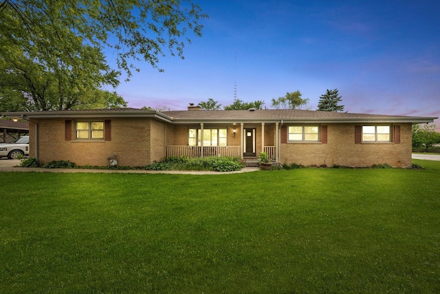 910 Sarah Ln, Aurora, IL 60502 - single story home featuring brick siding, a porch, a front yard, and a chimney