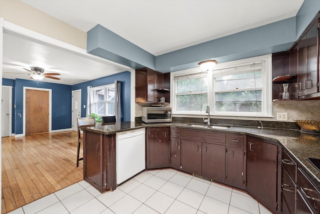910 Sarah Ln, Aurora, IL 60502 - kitchen with a sink, white dishwasher, open shelves, stainless steel microwave, and dark brown cabinets