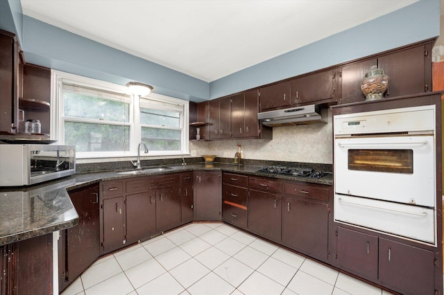 910 Sarah Ln, Aurora, IL 60502 - kitchen featuring oven, stainless steel microwave, a sink, a warming drawer, and under cabinet range hood