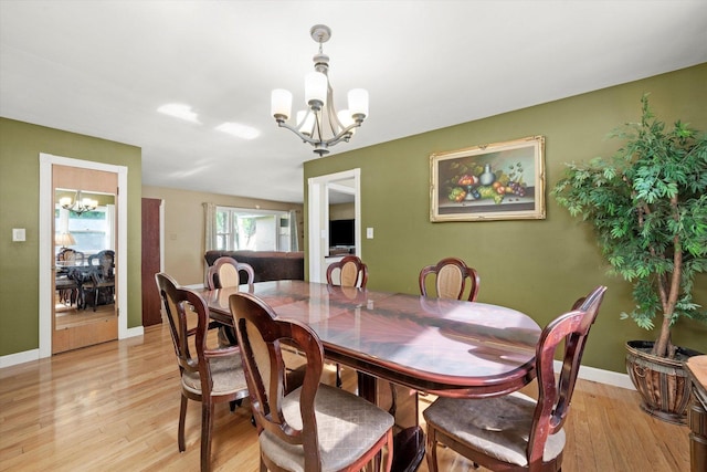 910 Sarah Ln, Aurora, IL 60502 - dining room with a chandelier, light wood-style floors, and baseboards
