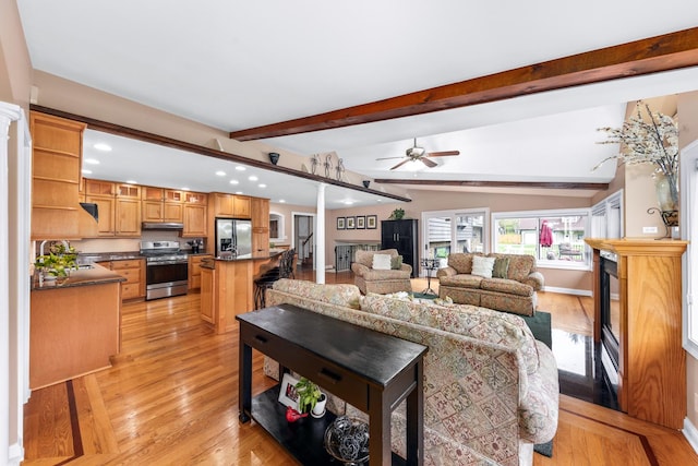 living room featuring beamed ceiling, recessed lighting, a ceiling fan, and light wood-style floors