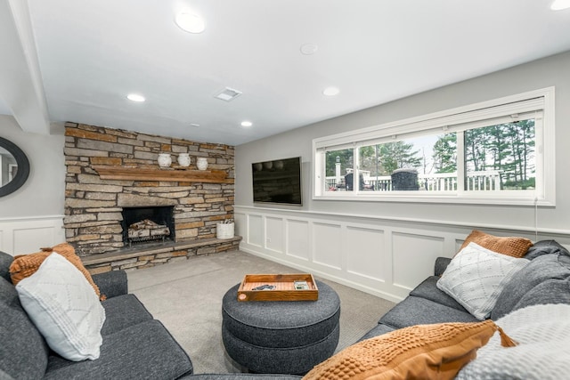 living room with a fireplace, carpet floors, a decorative wall, a wainscoted wall, and recessed lighting