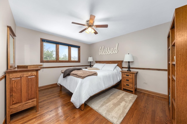 bedroom featuring baseboards, a ceiling fan, and wood finished floors