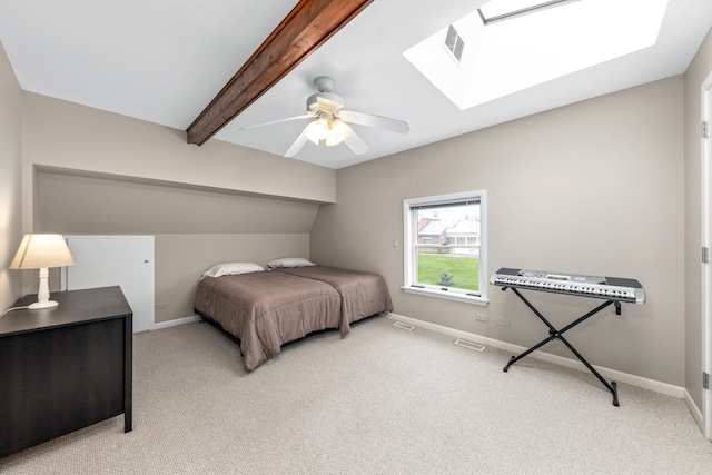 bedroom with carpet floors, visible vents, beam ceiling, baseboards, and a skylight
