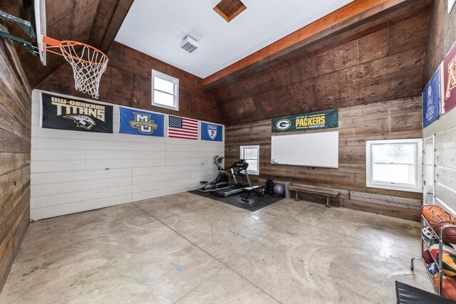 interior space with wood walls and vaulted ceiling
