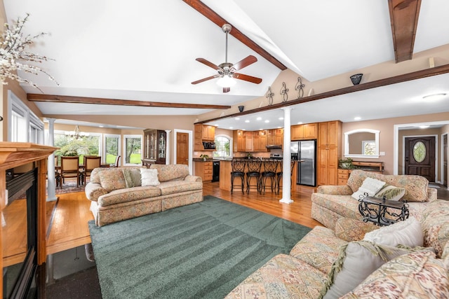 living room featuring recessed lighting, ceiling fan, vaulted ceiling with beams, and light wood-style floors