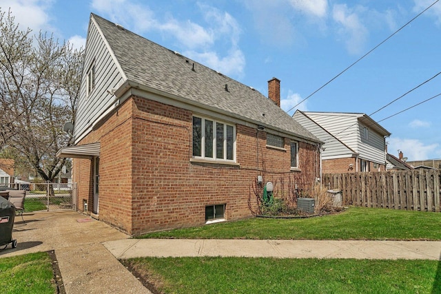 17531 Burnham Ave, Lansing, IL 60438 - back of property featuring a gate, fence, a yard, roof with shingles, and brick siding