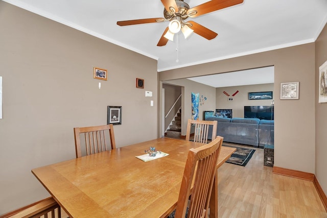 17531 Burnham Ave, Lansing, IL 60438 - dining space with crown molding, a ceiling fan, stairs, light wood finished floors, and baseboards