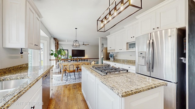 1531 Walnut St, Western Springs, IL 60558 - kitchen with appliances with stainless steel finishes, light wood-style floors, white cabinetry, and decorative light fixtures
